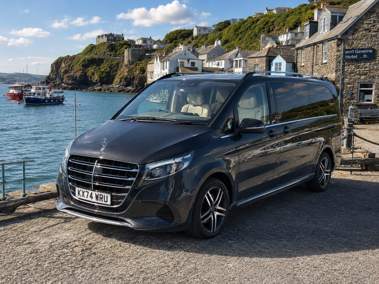 Mercedes V Class at Port Isaac harbour, Cornwall, with colourful fishing boats and stone cottages